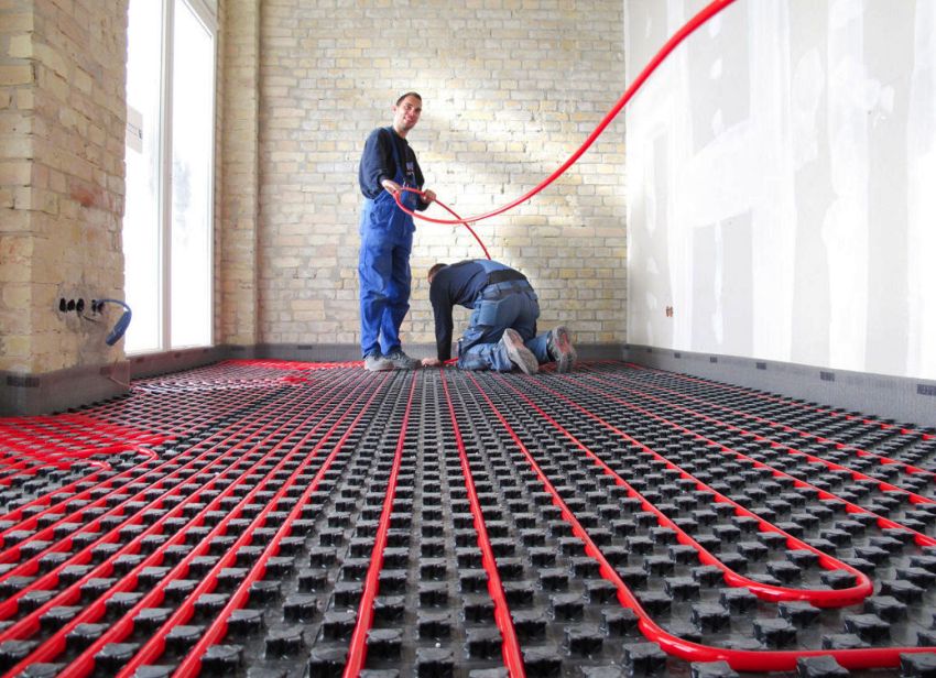 The initial stage of arranging a water-heated floor is laying a cross-linked polyethylene pipe on an insulating substrate The initial stage of arranging a water-heated floor is laying a cross-linked polyethylene pipe on an insulating substrate