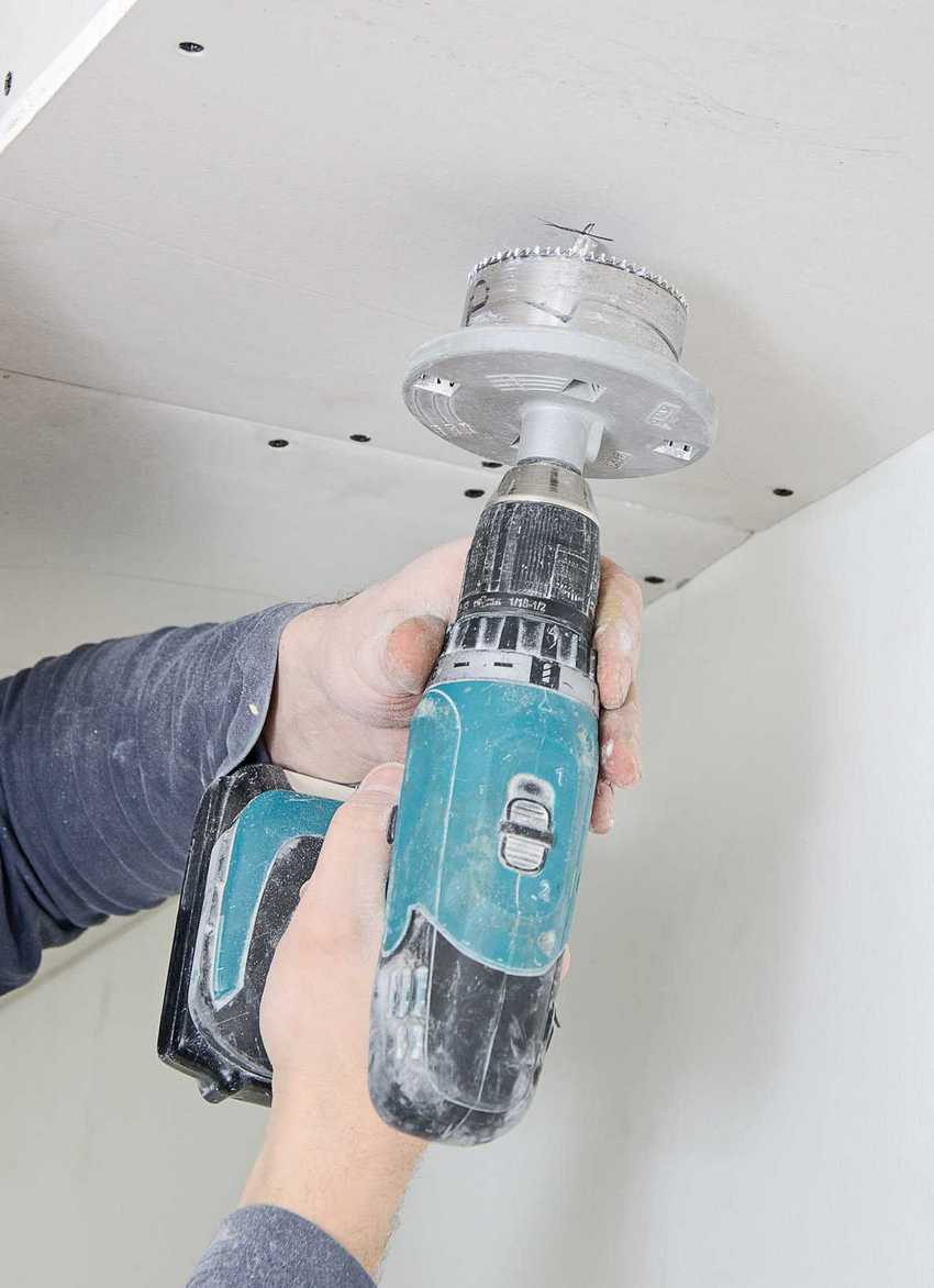 A drill with a special nozzle is used to cut holes for the lamps. A drill with a special nozzle is used to cut holes for the lamps.