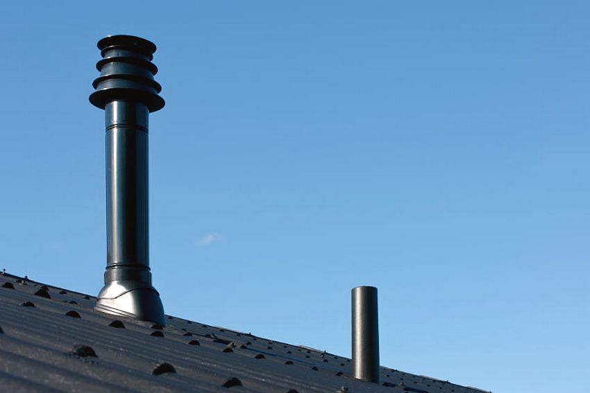 Chimney made of steel pipes on the roof of a private house Chimney made of steel pipes on the roof of a private house