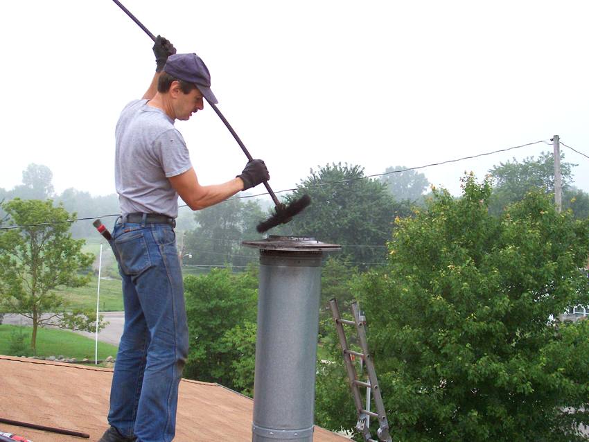 The process of cleaning the chimney from soot The process of cleaning the chimney from soot