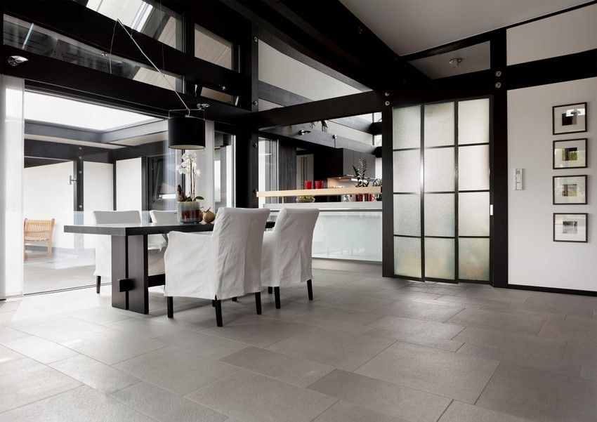 The sliding-type partition between the kitchen and the living room made of matte plastic is not only functional, but also ideally combined with the overall design of the room The sliding-type partition between the kitchen and the living room made of matte plastic is not only functional, but also ideally combined with the overall design of the room